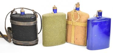 Four British WW1 blue enamel water bottles / canteens, three with covers and webbing, all with