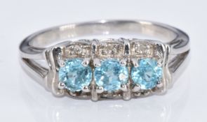 A 9k white gold ring set with three round cut zircon and diamonds, with certificate, 4.2g, size O