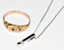 A 9ct white gold pendant set with a diamond, on 9ct white gold chain and a yellow metal ring (ring