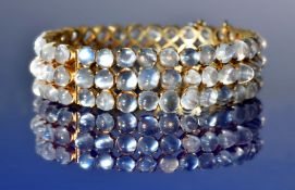 A silver gilt bracelet set with moonstone cabochons in three rows, 25g