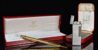 Cased Must de Cartier ballpoint pen and a cased silver plated Dunhill Rollagas lighter PLEASE NOTE