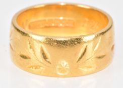 A 22ct gold wedding band / ring with cut out floral decoration, by Goldsmiths & Silversmiths