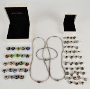 Two Pandora necklaces and a bracelet with twenty two silver and glass beads and thirty-seven