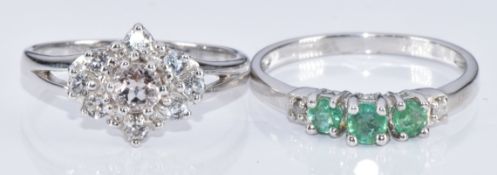 Two 9k white gold rings, one set with a round cut morganite and topaz and the other emerald and