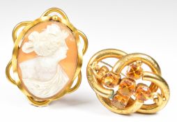 Two Victorian pinchbeck brooches, one set with paste and the other a cameo of a young woman, 6.5 x