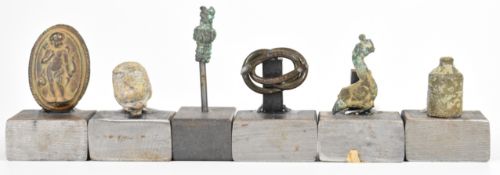 Antiquities a collection of Roman and later artefacts, mounted on steel plinths, tallest 8cm