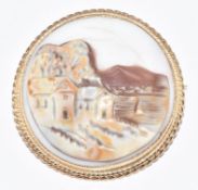 A 9ct gold brooch set with a cameo of a coastal scene, 6.8g, 2.7cm