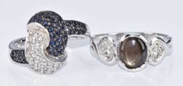 Two 9k white gold rings, one set with blue sapphires and topaz and the other a star sapphire and