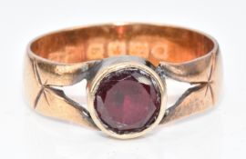 A 22ct gold ring set with a round cut garnet, 4.8g, size P
