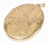 A 9ct gold locket with engraved scrolling decoration, 10g, 3.1 x 4cm