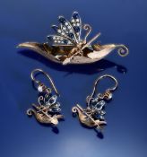 An 18ct gold brooch and matching earrings, each in the form of a leaf being used as a boat and