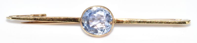 A 9ct gold brooch set with an oval cut sapphire of approximately 2.3ct, 3.3g, 5cm