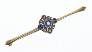 A 15ct gold brooch set with three round cut sapphires and seed pearls, 4.4g, 6cm
