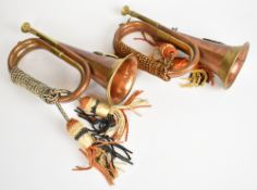 Two brass and copper military bugles, with ropes and knots and regimental insignia for the Argyll