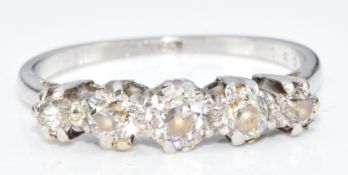 A platinum ring set with five old cut diamonds, the centre diamond approximately 0.3ct, 3.4g, size