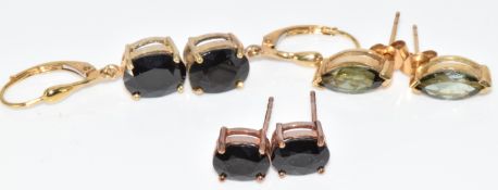 Three pairs of 9k gold earrings set with green tourmaline and two pairs set with black spinel,