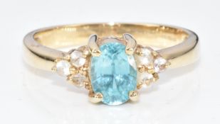 A 9ct gold ring set with an oval cut zircon and cubic zirconia, 3.1g, size M/N