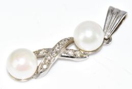 A 9ct white gold pendant set with two pearls and diamonds, 2.4g, 3cm