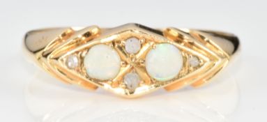 A c1900 18ct gold ring set with two opals and two rose cut diamonds, 2.1g, size O/P