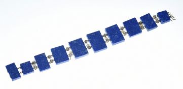A c1910 bracelet made up of ten rectangular lapis lazuli panels, old cut diamonds and pearls,