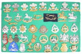 Approximately 42 cap badges and insignia including Leinster, Welch, The Welsh, Cheshire Earl of