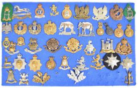 Forty one cap badges and insignia including two 19th P.W.O (Princess of Wales) Alexandra Hussars