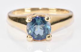 A 9ct gold ring set with a round cut treated topaz, 4g, size N