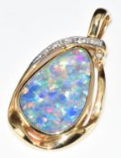 A 14k gold pendant set with an opal doublet and diamonds, 8.7g, 4.2cm