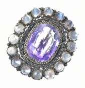 A silver gilt brooch set with an amethyst surrounded by moonstones, 5.4g, 2.5 x 2.2cm