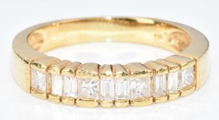 An 18ct gold ring set with four princess cut and six emerald cut diamonds, the total diamond