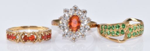 Three 9ct gold rings, one set with tsavorite, one fire opal and topaz and the other fire opal,