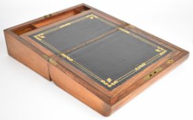 19th century walnut writing slope opening to reveal a tooled leather writing surface, inkwell and