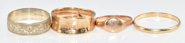 Four 9ct gold rings comprising one with feature hallmarks, a white gold wedding band, another