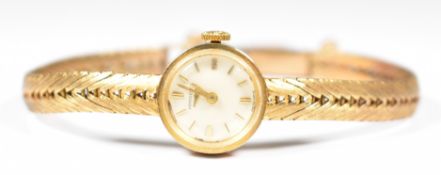 Longines 9ct gold ladies wristwatch with gold hands and hour markers, silver dial and signed 17