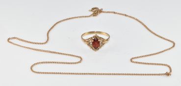 A 9ct gold ring set with a garnet (1.5g, size P) and 9ct gold chain (2.2g, 43cm)