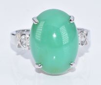A 9k white gold ring set with a chrysoprase cabochon and topaz, with certificate, 6.7g, size N
