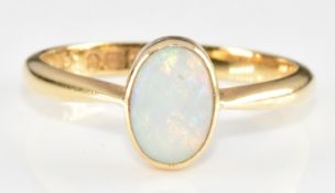 An 18ct gold ring set with an opal cabochon, 2.9g, size O/P