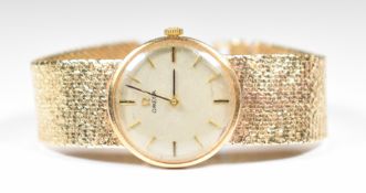 Omega 9ct gold ladies wristwatch with black hands, two-tone baton hour markers, silver dial and