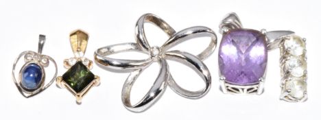 A 9ct gold pendant set with paste (0.8g), 9ct white gold pendant (1.1g) and three silver pendants (