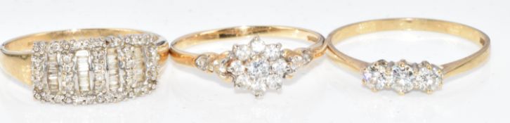 Three 9ct gold rings, one set with round and baguette cut diamonds and the other two cubic zirconia,