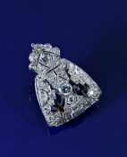 Art Deco platinum clip set with round cut and two baguette cut diamonds, largest diamond