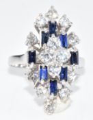 An 18ct white gold ring set with round cut diamonds and baguette cut sapphires, the largest