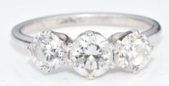 A platinum ring set with three round brilliant cut diamonds measuring approximately 0.6ct, 0.