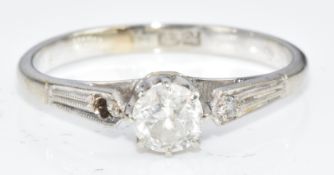 An 18ct white gold ring set with a round cut diamond of approximately 0.3ct, (diamond missing to the