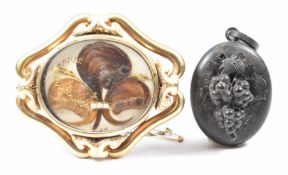 Victorian gold plated mourning brooch set with hair, and a carved jet locket in antique box