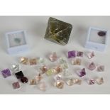 A collection of loose uncut fluorite stones (533ct), a 1.5ct chalcedony cabochon, 2.5ct ruby