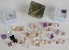 A collection of loose uncut fluorite stones (533ct), a 1.5ct chalcedony cabochon, 2.5ct ruby