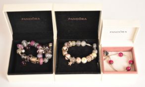 Three Pandora silver bracelets, one with fifteen charms, one eighteen charms, and the other four