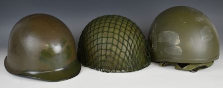 Three helmets, possibly re-enactment examples, comprising a British M76 helmet and two other metal