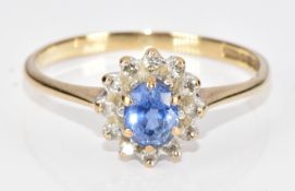 A 9ct gold ring set with an oval cut sapphire of approximately 0.3ct surrounded by diamonds, 1.4g,